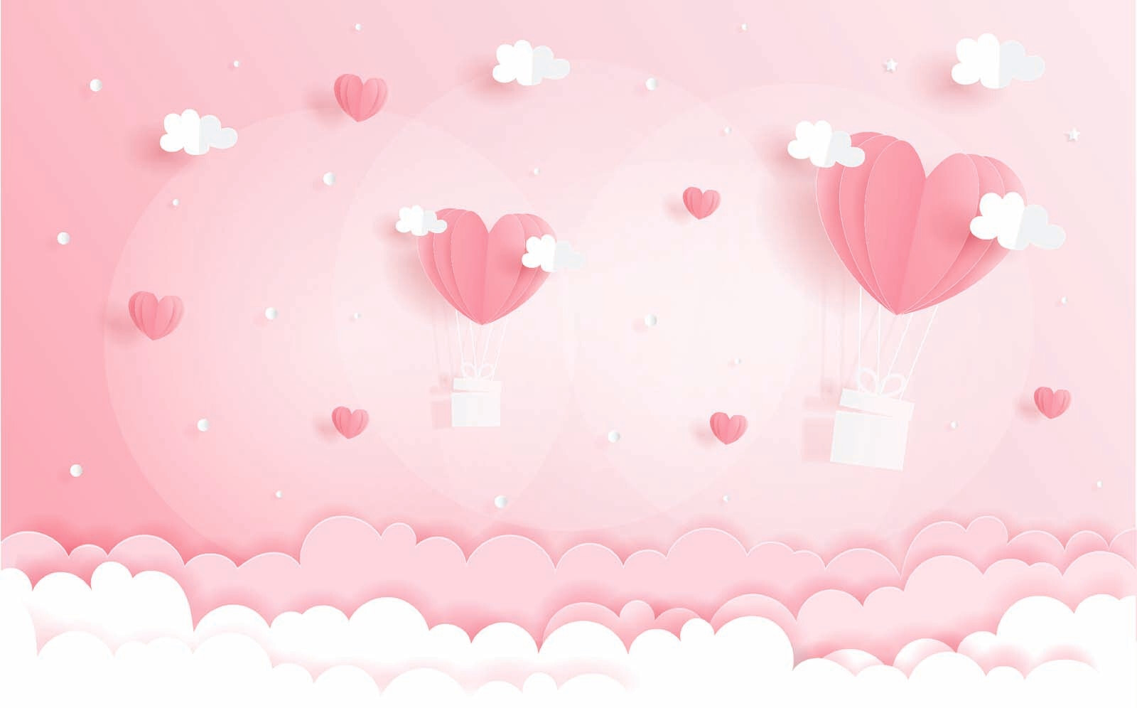 Pink paper cutout of hot air balloons and clouds