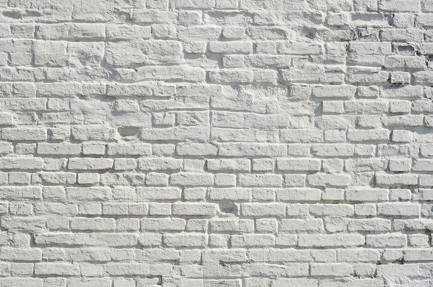 White brick wall with black spots White brick wall with black spots
