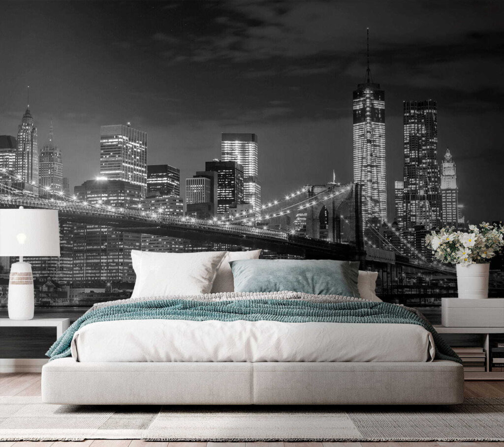 Bridge over water with city skyline at night