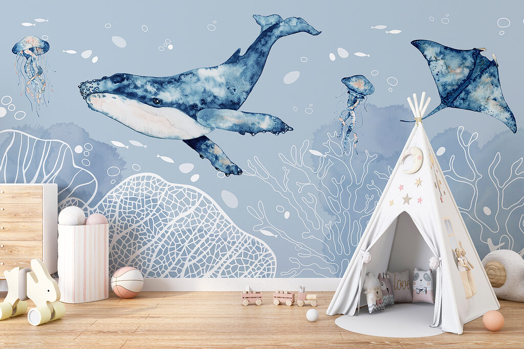 A whale and stingrays swimming in the ocean