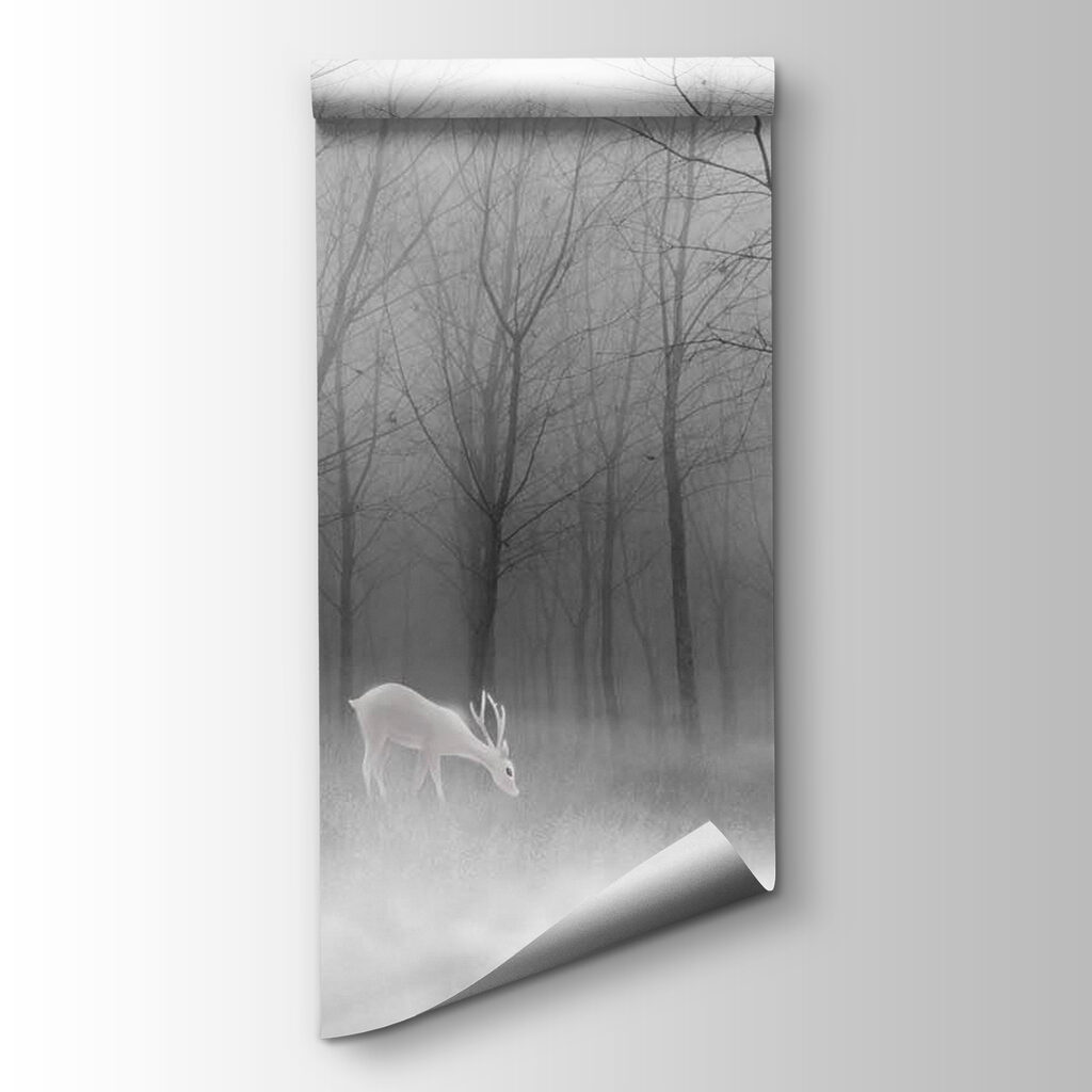 Group of white deer in a foggy forest