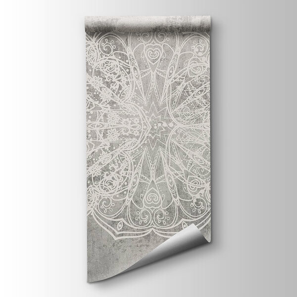 White ornate design on a grey surface